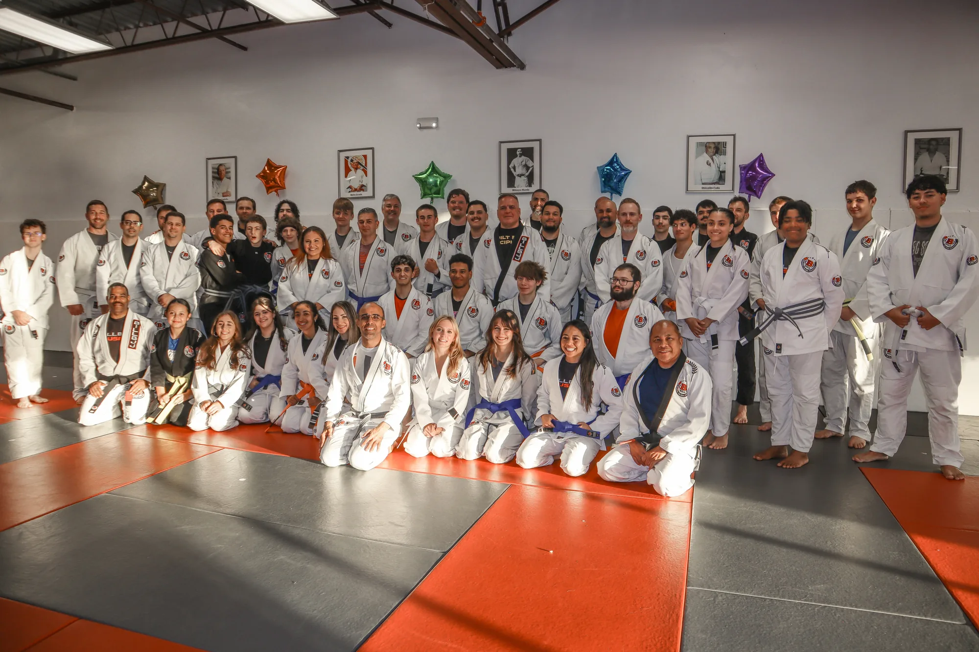 The teens and adults of the academy gathered on the mat in their gis after a belt ceremony